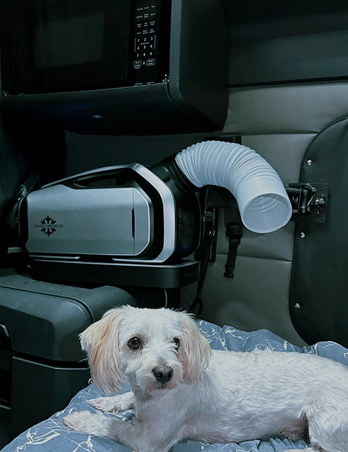 The Mark 2, with its flexible duct, keeps a white puppy cool and comfortable in a truck cab.