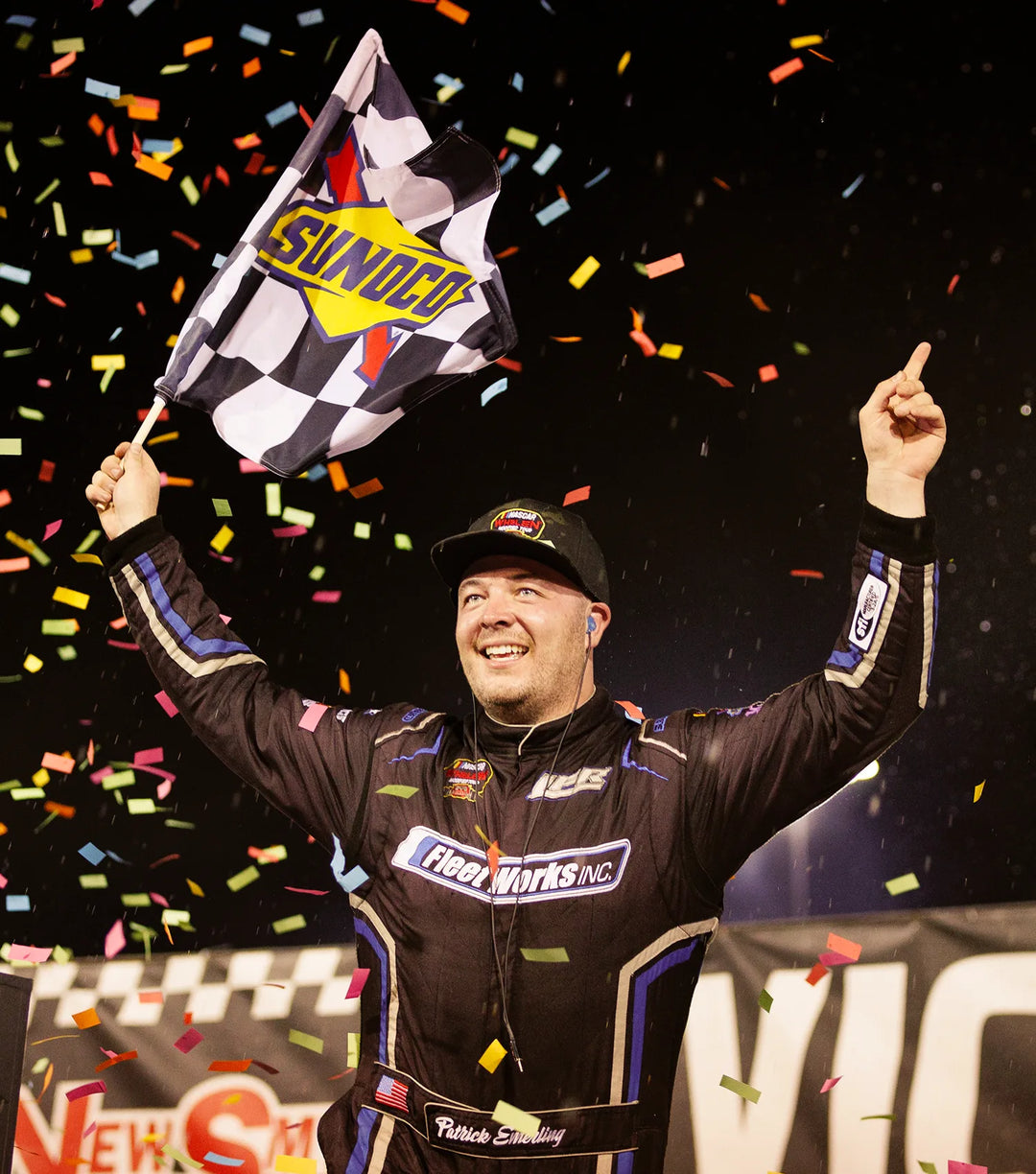 Patrick Emerling celebrates race victory with a checkered Sunoco flag and confetti falling around him.