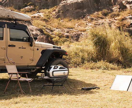 A Mark 3 battery is recharged by solar panels while simultaneously powering the Mark 3 portable air conditioner.